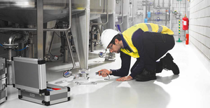 Load cell technician performing maintenance inspection